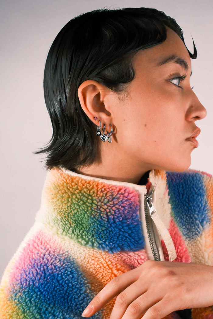 Person wearing multiple silver earrings