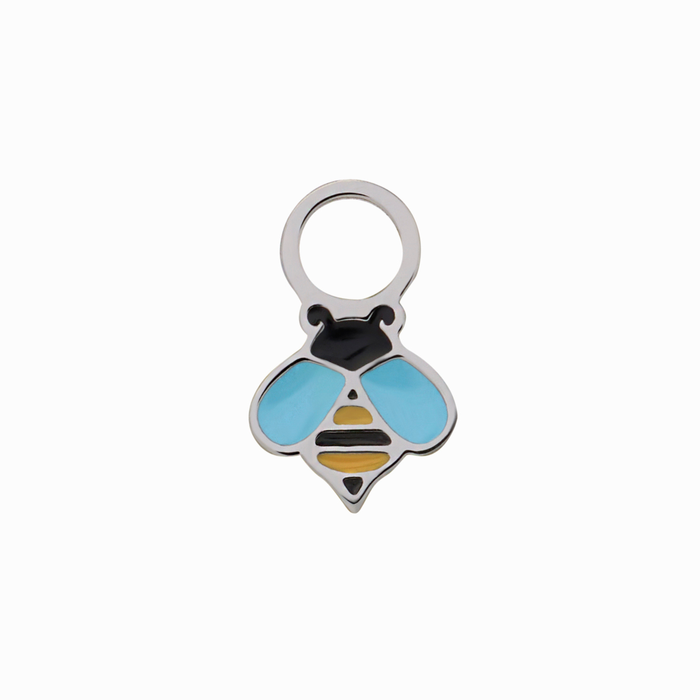 A close up of a bumblebee shaped hoop charm with yellow and black enamel and titanium metal on a white background