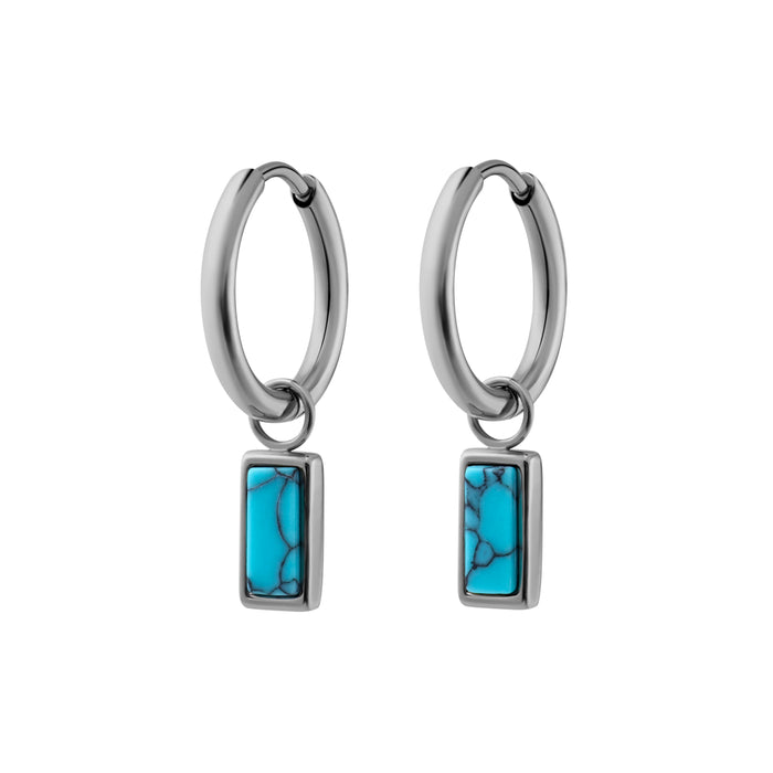 Pair of hoop earrings with faux turquoise stone pendants on a white background