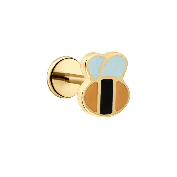 A close up of a bumblebee shaped flat back stud with yellow and black enamel and gold-plated titanium metal on a white background