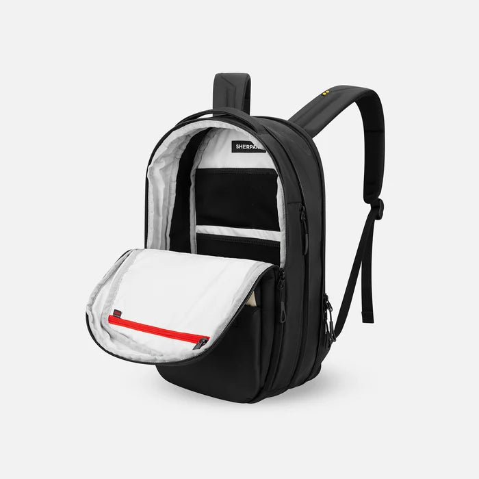 A Sherpani Camden Ciao Ultimate Backpack, 3/4 view showing inside of main pocket on a white background.    #color_ciao-print
