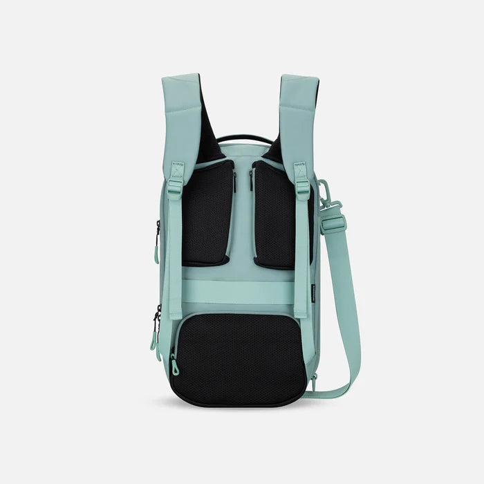 A Sherpani Camden Surf Blue Ultimate Backpack, back view showing shoulder straps and luggage strap on white background.  #color_surf-blue