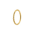 Gold ring with textured design on a white background
