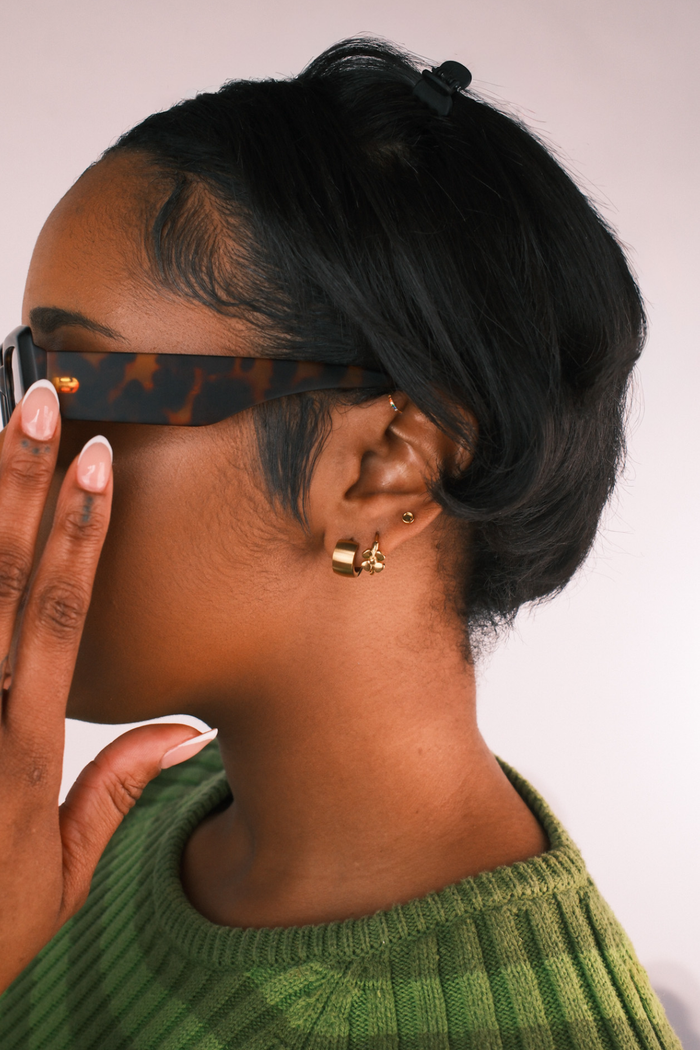 Woman wearing multiple gold earrings