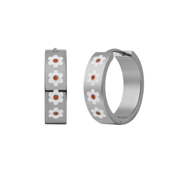 A close up of a hoop earring made from titanium metal, with a line enamel daisy in white and yellow decorating the hoop on a white background