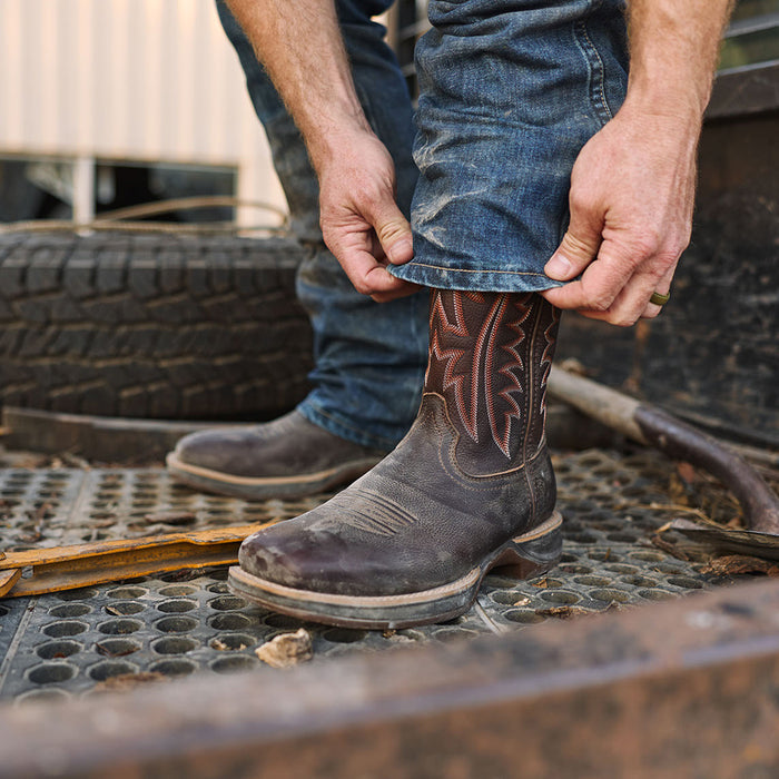 Person wearing a brown Durango Rebel Ultra Lite western work boot on the back of a metal truck bed.