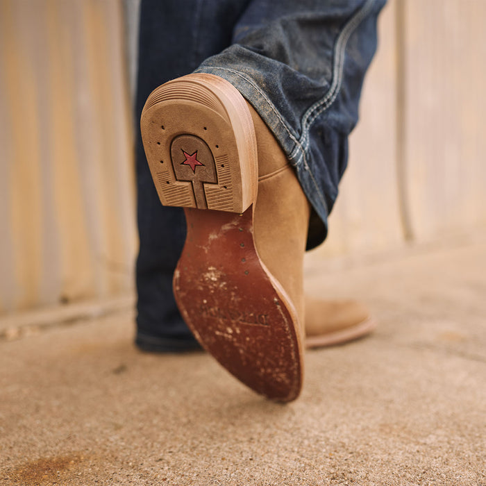 Close-up of the leather sole of a Durango roper boot with a red star.