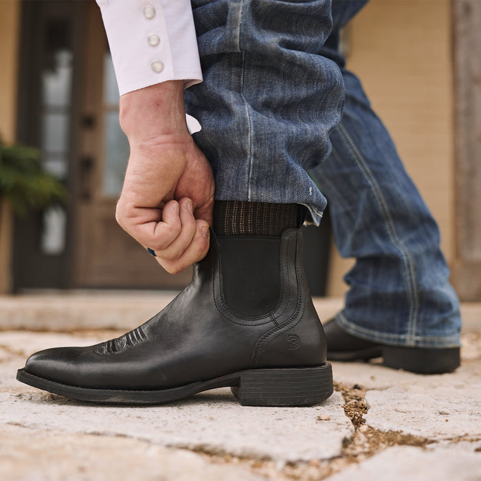 Man adjusting Durango black chelsea boots