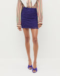 Elowen Crochet Skirt in jewel purple crocheted cotton, Ken Shirt in tan, green, and red stripes, and Marsy Jewel Suede Knot Wedge.