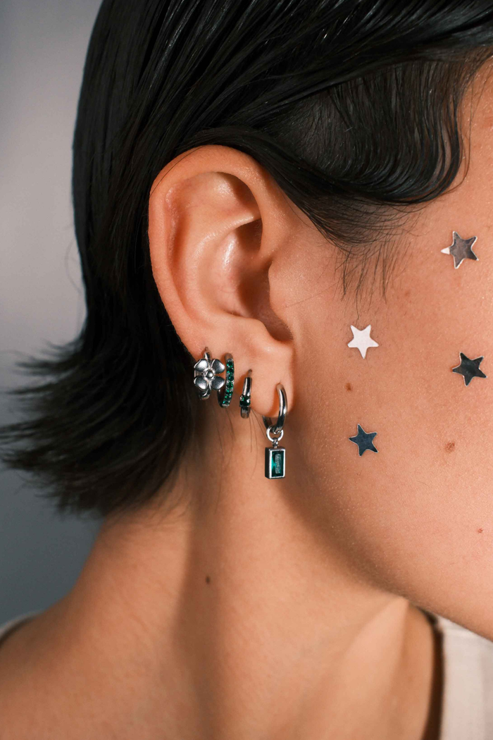 Close-up of an ear with multiple earrings