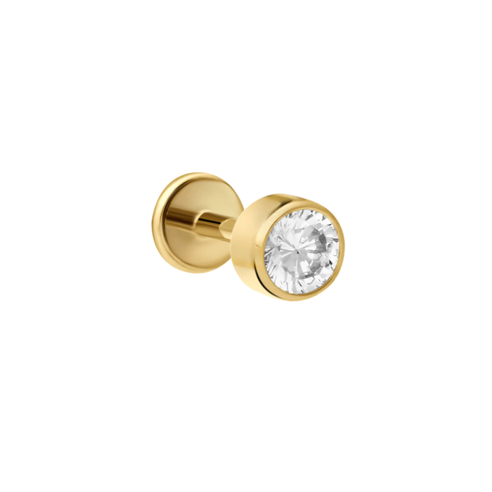 Close up of push-pin style flat back stud made from ASTM F136 Implant Grade Titanium, plated with18K gold pvd plating. The flat back stud design is a bezel-set round zirconia stone, clear in color.