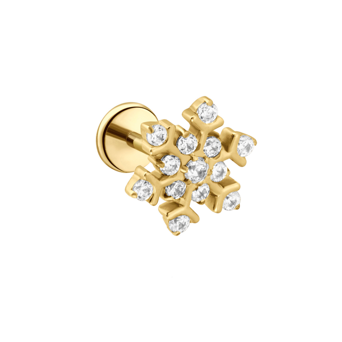 Gold snowflake earring with clear gemstones on a white background