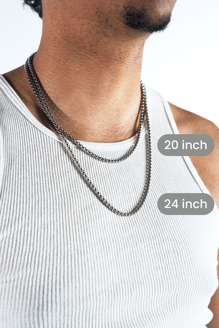 A close-up of a man wearing two silver-toned chain necklaces over a white ribbed tank top, with overlaid labels showing 20 inch and 24 inch lengths.