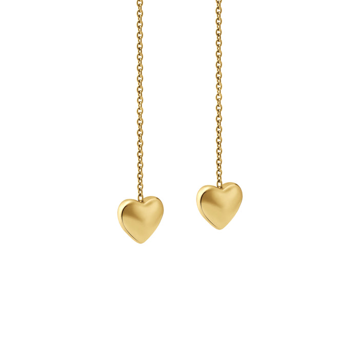 Zoomed-in view of gold heart-shaped threader earrings on a white background
