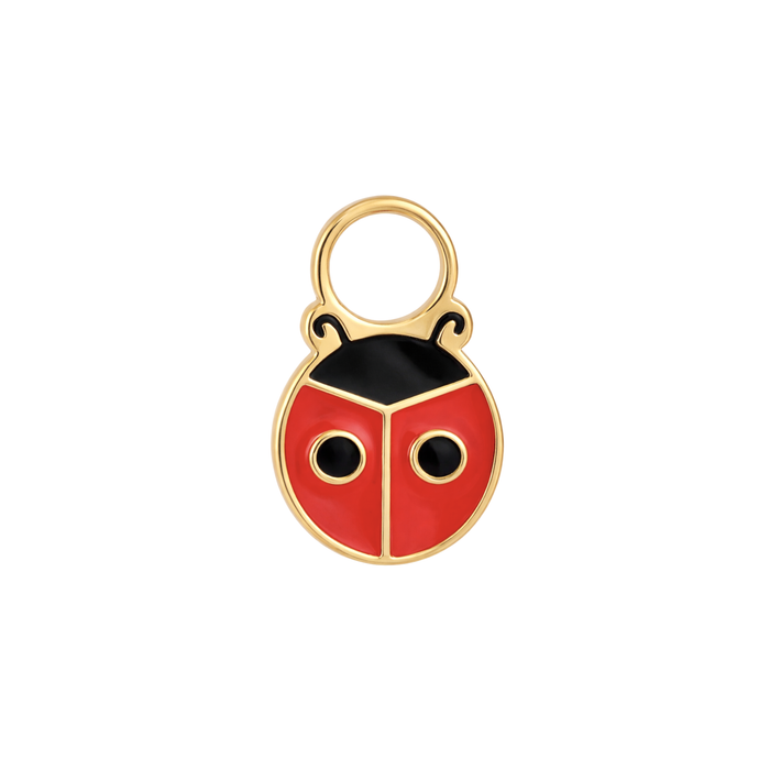 A close up of a ladybug shaped hoop charm with red and black enamel and gold-plated titanium metal on a white background
