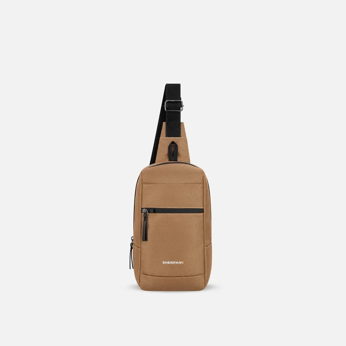 A Sherpani Metro Sand Anti-theft Reversible Sling, front view showing lockable pocket and main strap on white background. #color_sand-tan