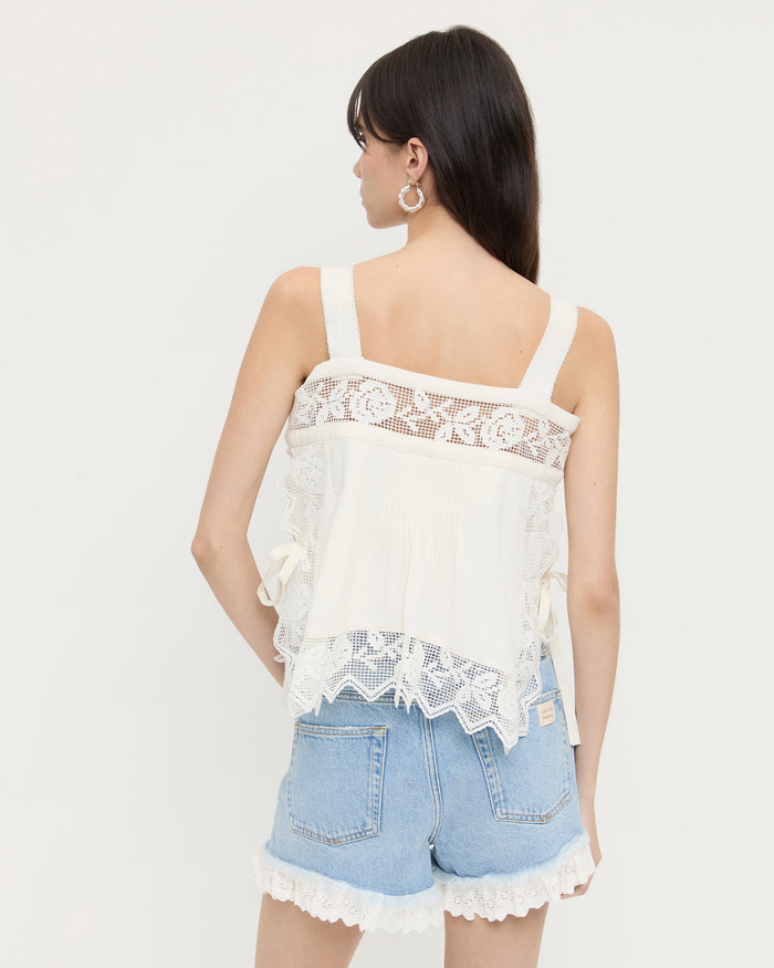 Pia Top in white cotton and Kay Lace-Trimmed Denim Shorts in light blue denim with white lace trim.
