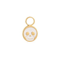 Gold hoop charm with a white enamel skull design on a white background