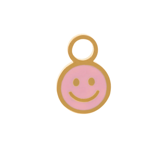 A small smiley face charm with a gold-tone metal border and loop, featuring a light pink enamel face on a white background.