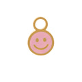 A small smiley face charm with a gold-tone metal border and loop, featuring a light pink enamel face on a white background.