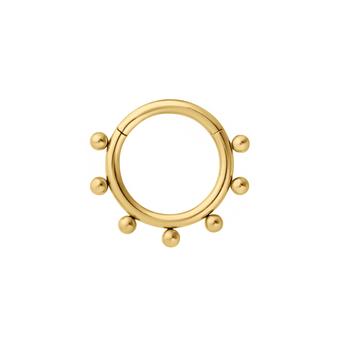 Close up of a clicker-style hoop featuring a series of round metal details that radiate from the main hoop. Designed for Daith or Septum piercings, and made from ASTM F136 Implant-Grade Titanium, finished with 18K Gold PVD plating