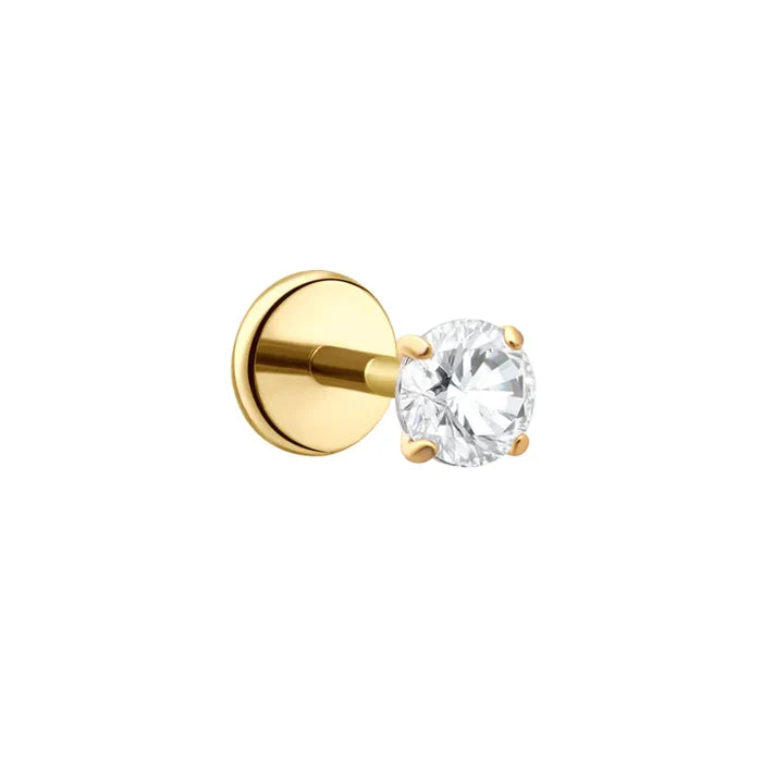 A single gold stud earring featuring a round brilliant-cut clear CZ stone in a four-prong setting, shown against a solid white background.