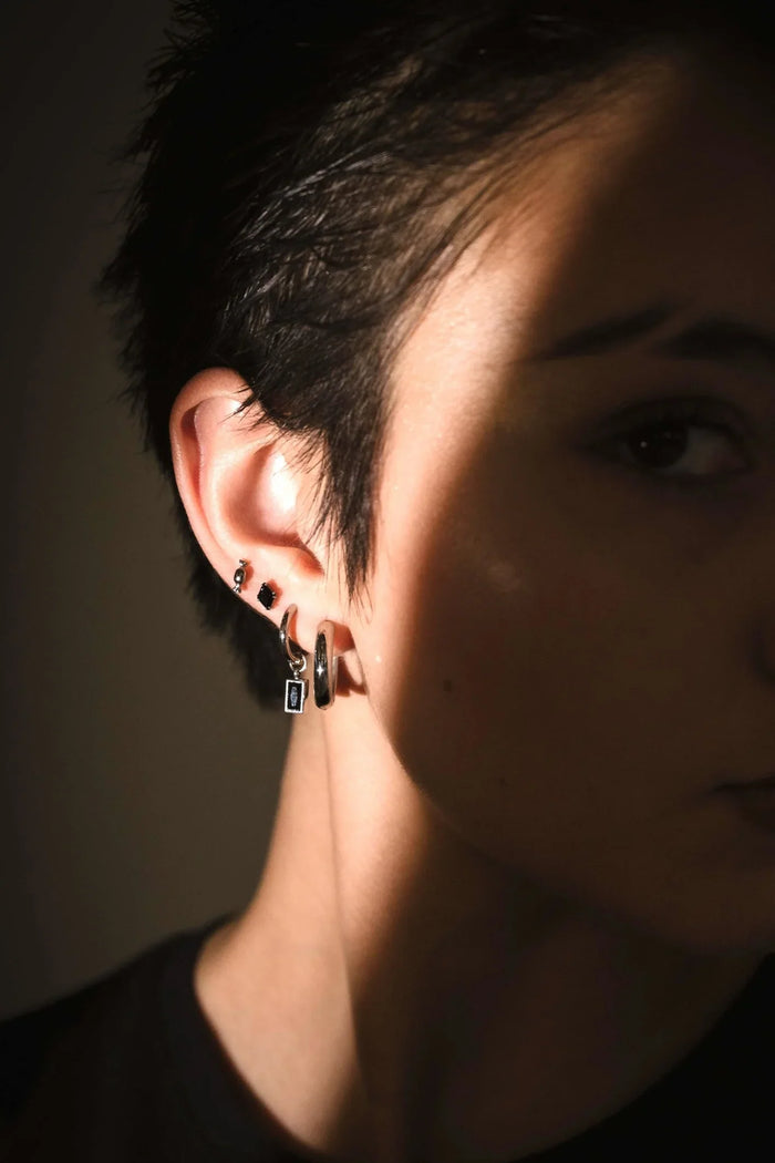 Model photo showcasing black and silver flat backs and hoops