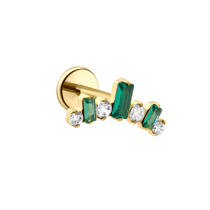 Gold earring with green and clear gemstones on a white background