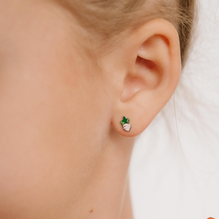 A close up of a turnip shaped flat back stud with blush pink enamel and titanium metal.