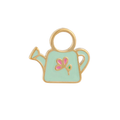 A close up of a watering can shaped hoop charm with mint green enamel and gold-plated titanium metal on a white background